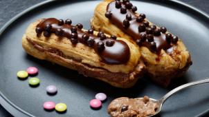 Two chocolate éclairs on a plate, eclair