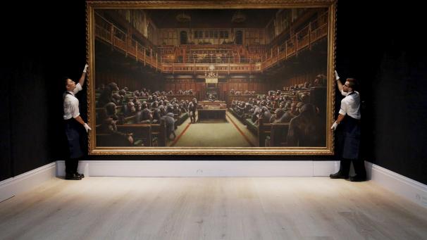 La toile de Banksy «
Devolved Parliament
», où des chimpanzés ont pris le contrôle de la chambre des représentants britannique a été adjugée à plus de 11 millions d’euros aux enchères.