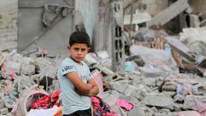A Palestinian boy stands amid the rubble of a residential building destroyed by an Israeli strike in Al-Zawayda in the central Gaza Strip on May 11, 2024, amid the ongoing conflict between Israel and the Hamas movement. (Photo by AFP)