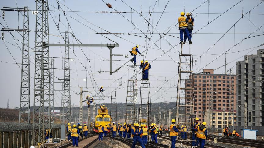 En Chine, des employés travaillent à la construction du chemin de fer reliant Tangshan à Hohhot.