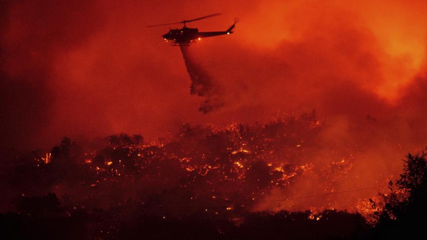 Un hélicoptère largue de l’eau sur un incendie le long de l’autoroute 154 dans la forêt nationale de Los Padres en Californie, au-dessus de Santa Barbara.