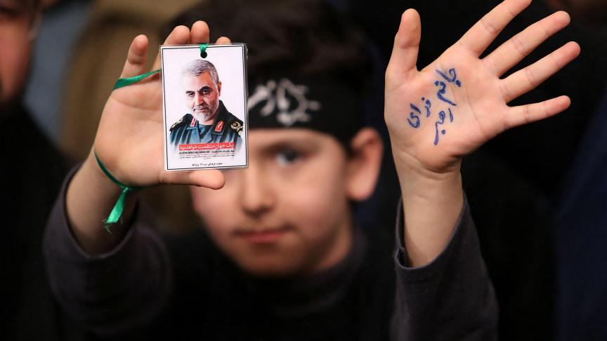 Un jeune homme tient la photo du général iranien Qassem Soleimani, lors d’une cérémonie en hommage à l’homme tué par une attaque ciblée menée par les États-Unis.