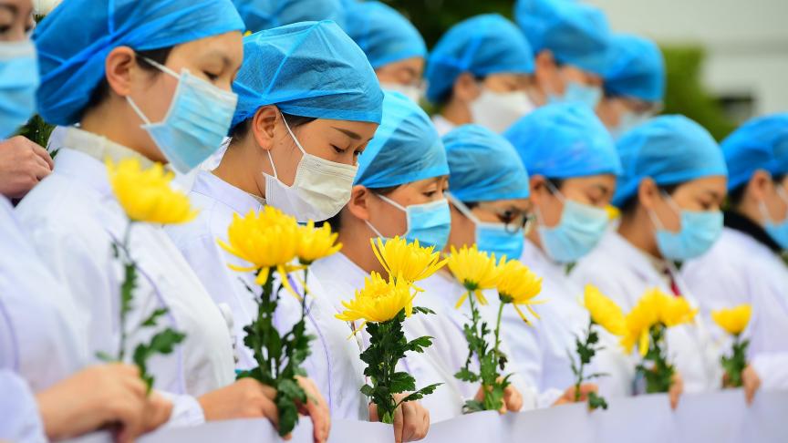 Le personnel médical d’un hôpital rend hommage aux victimes du coronavirus en Chine.