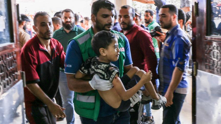 Un médecin transporte un enfant palestinien blessé lors de frappes aériennes israéliennes dans un hôpital de Khan Yunis, dans le sud de la bande de Gaza.